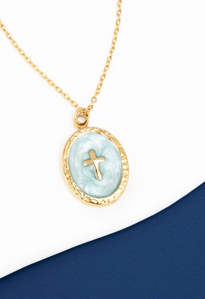 Necklace with a gold chain and light blue pendant featuring a cross on a white background.