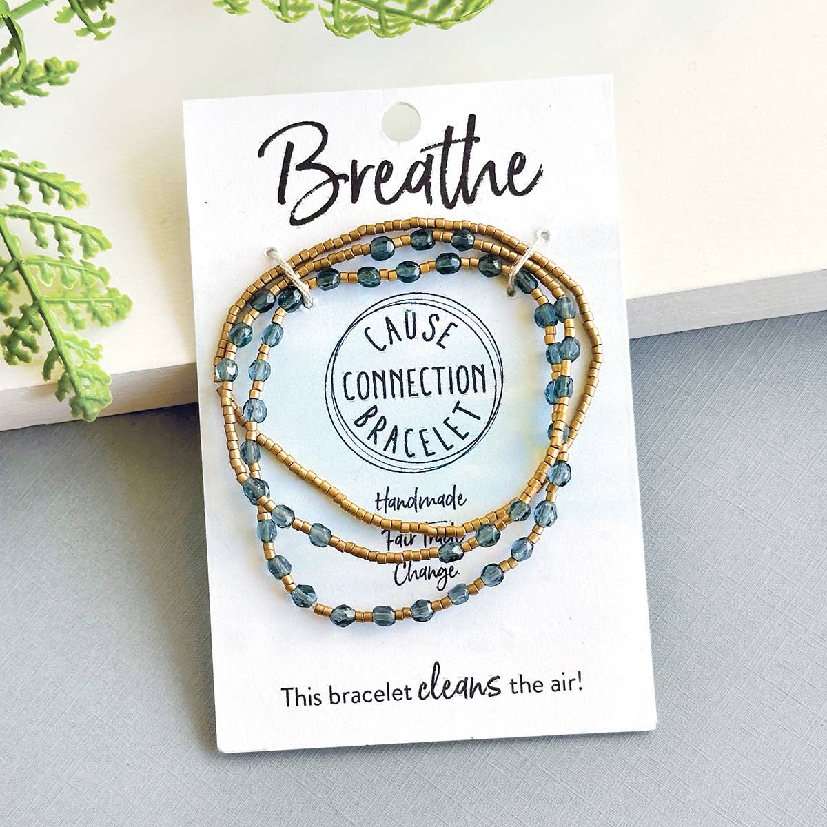 Gray handmade Breathe Cause Connection bracelet styled with natural details, a meaningful bracelet that helps remove air pollution.